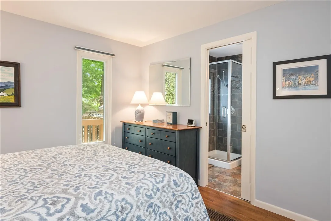 Main floor bedroom leading to full bathroom