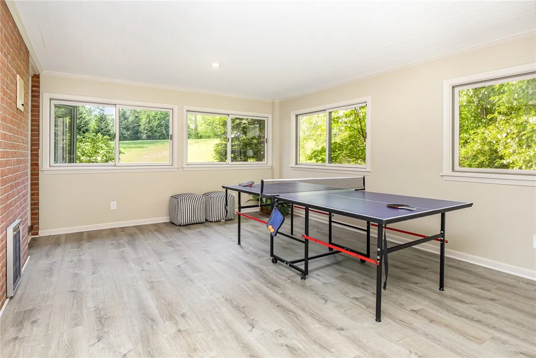 This 3 season sunroom has new windows, luxury  vinyl flooring and a slider out to the back patio.