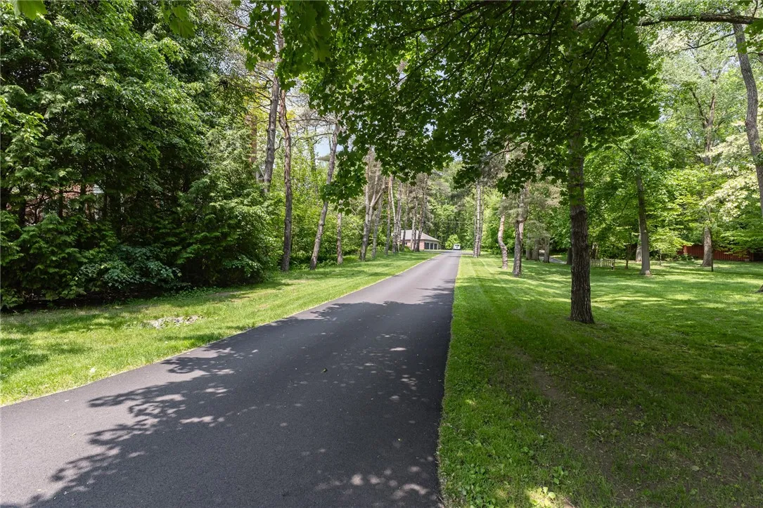 A long private tree lined driveway leads  to the home