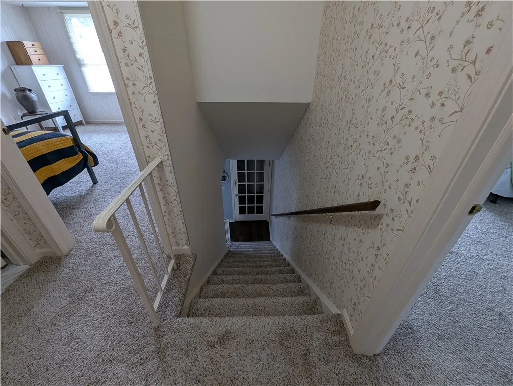VIEW FROM UPSTAIRS LANDING TO FRONT ENTRANCE. 3RD BEDROOM IS ON THE LEFT