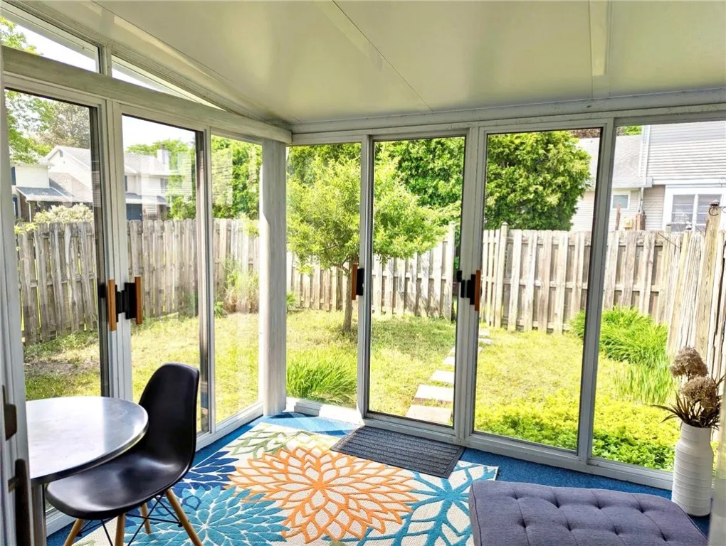 3 SEASON ROOM W/ GLASS DOORS W/ SCREENS OPENING ON 2 SIDES & ONE WALL W/ VERTICAL BLINDS. ELECTRICAL OUTLETS & CABLE CONNECTION

