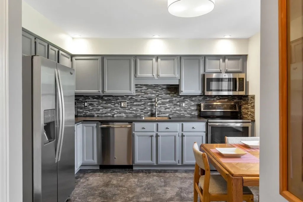 BRIGHT UPDATED EAT-IN KITCHEN HAS AN ENTRY FROM THE GARAGE AND PANTRY CLOSET