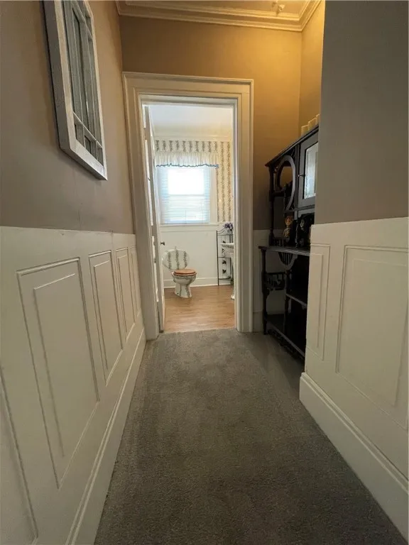 Side hall leads to downstairs half bath.