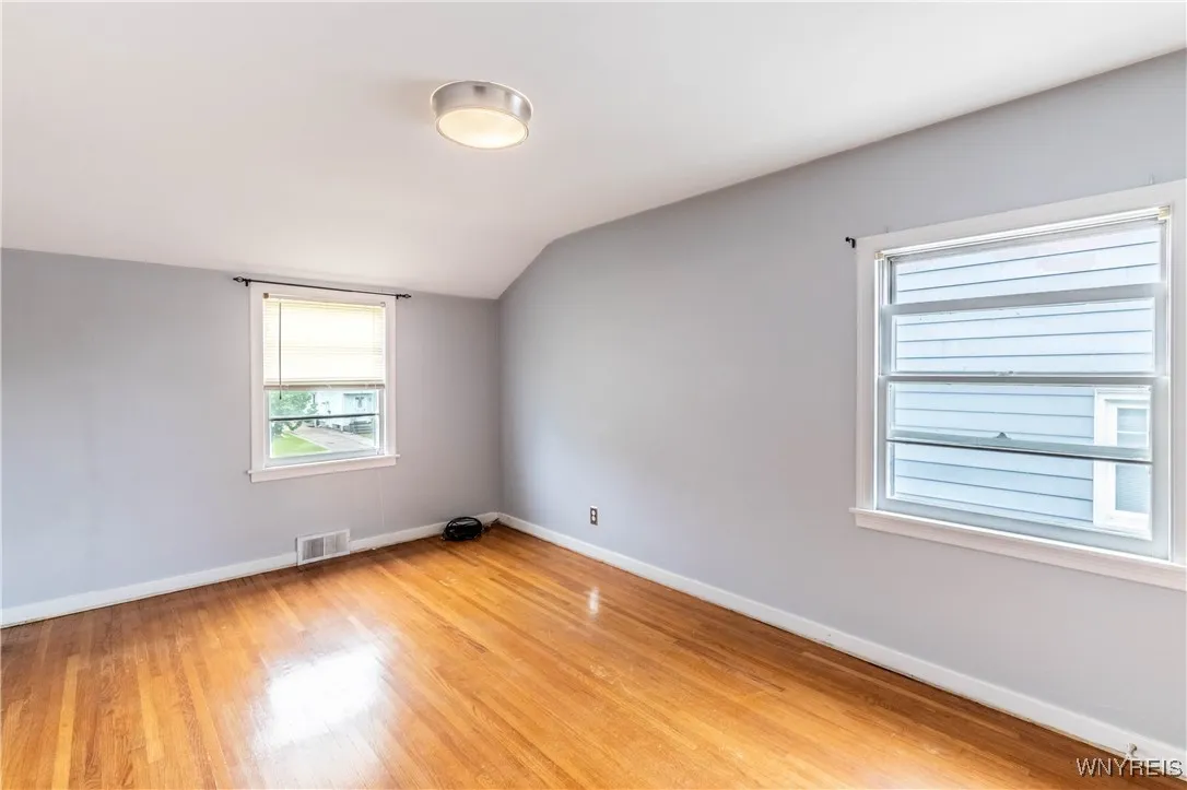 Primary bedroom has windows on both front and side of house.