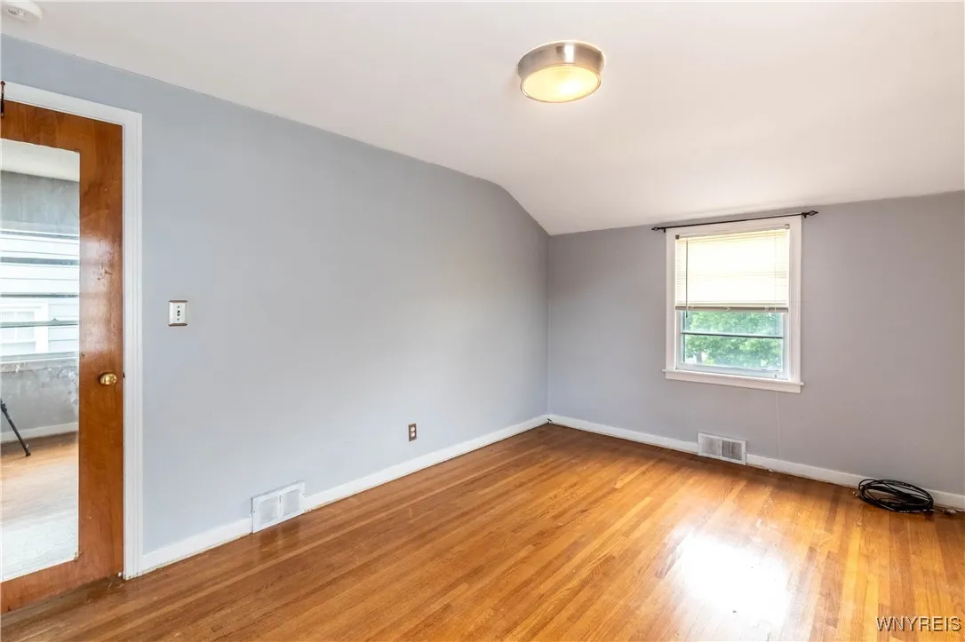 Primary bedroom is nice and big!  All the floors upstairs have been hidden by carpet for many years.  They will look even better once sanded down and refinished!