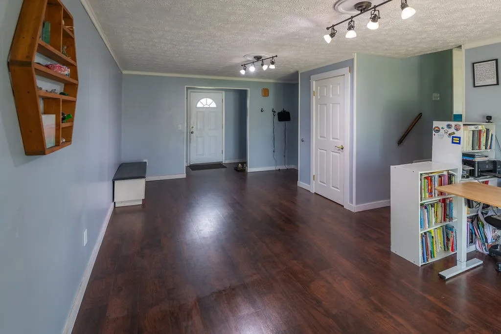 Main entry that doubles as a 2nd living space, newer floor, paint, lighting