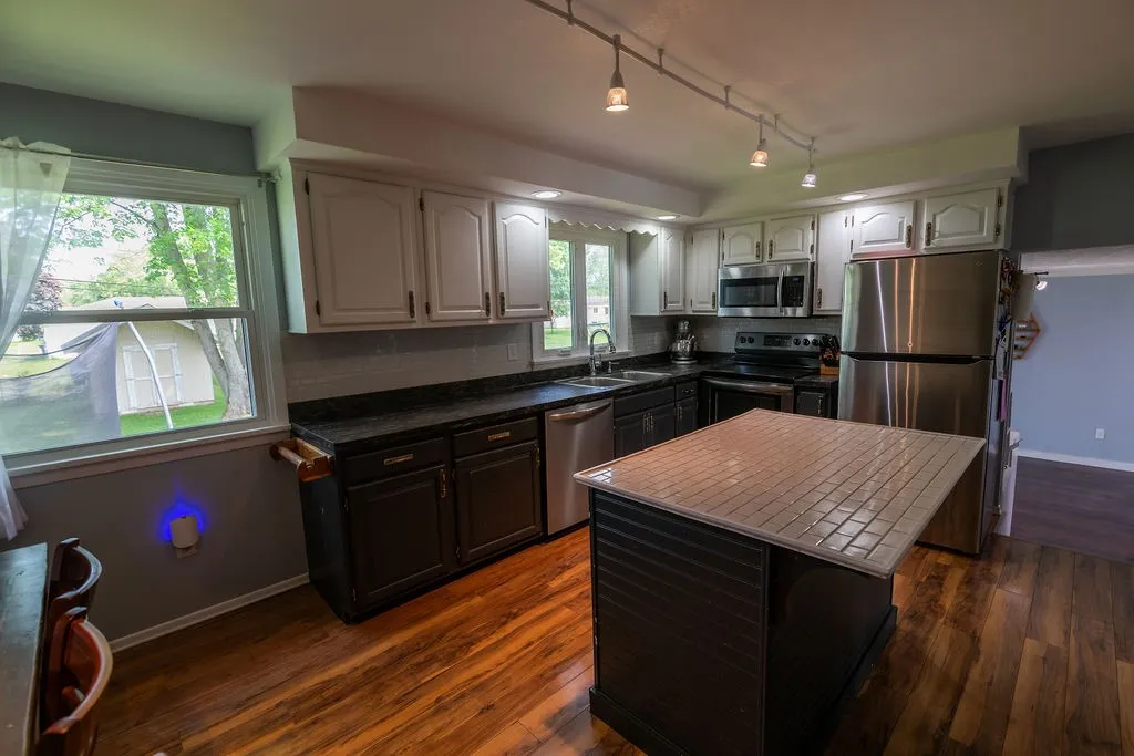 Kitchen has redone counters in 2021, an island with breakfast bar for stools and newer stainless steel appliances.
