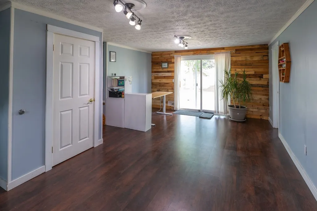 Main entry hall or second living space, room for office, half bath to the right, and slider to outside patio