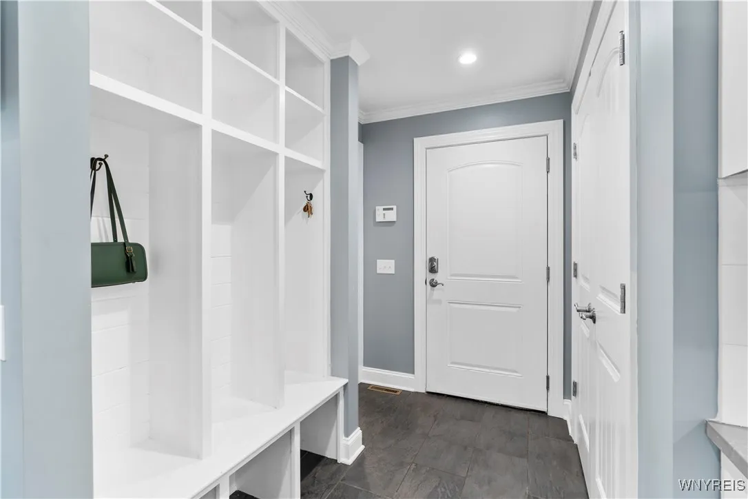 Mudroom off the kitchen. Garage is ahead, half bath to the left