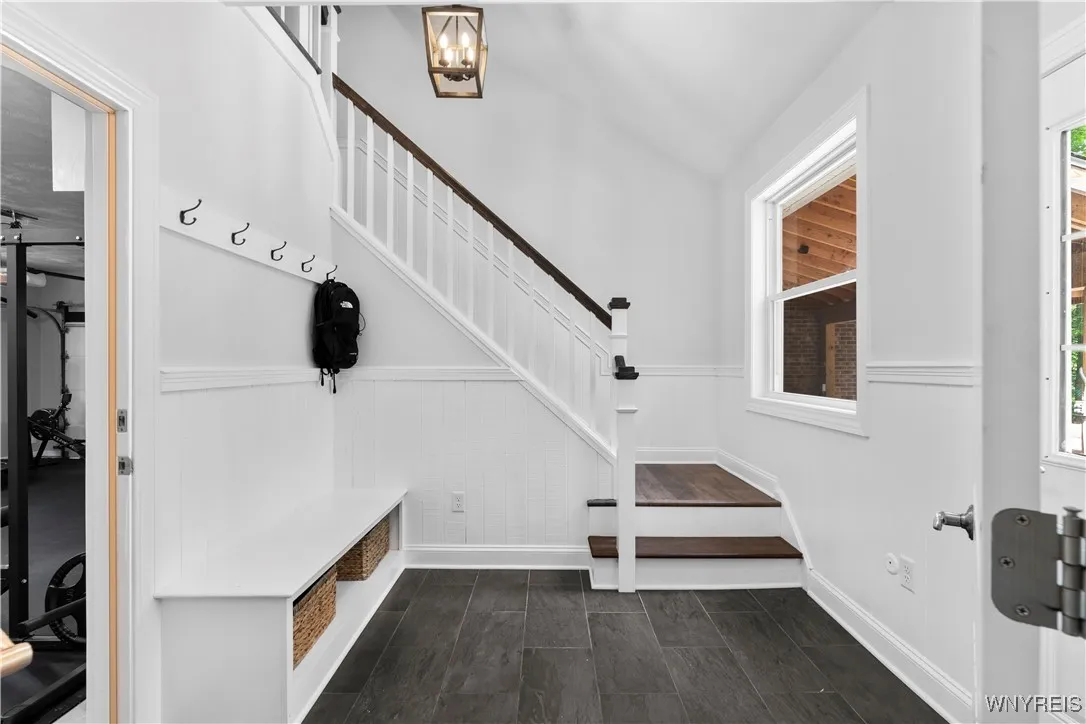 Rear mudroom and  staircase off the family room. Garage is to the left, yard to the right