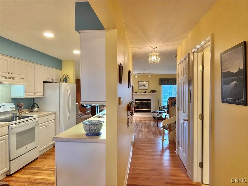 Looking towards the living room from the foyer.  Full bath and entry to the basement are on the right.
