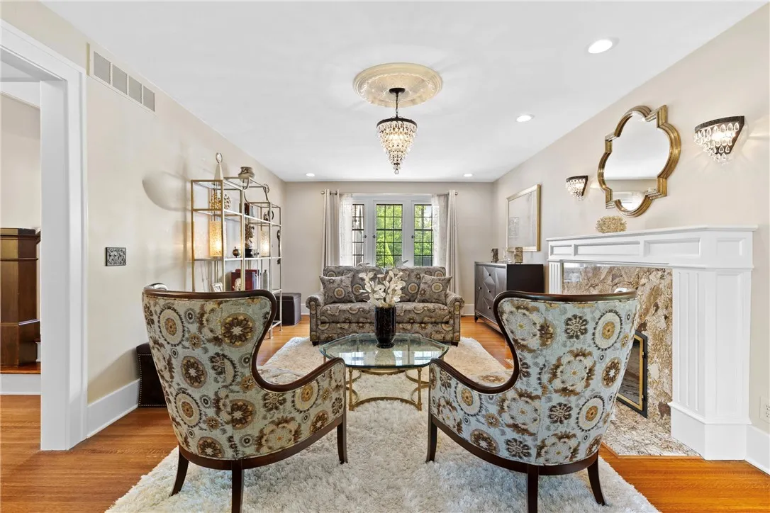 This formal living room has a wood burning fireplace and views of the front and back yards.