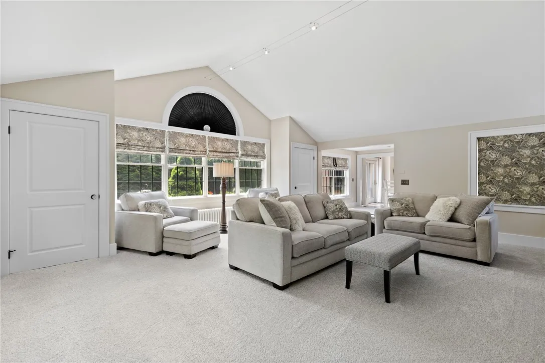 This addition was thoughtfully designed to complement the original architecture, featuring matching trim, black window grids that echo the look of leaded glass, and arched windows that reflect the home’s original character.