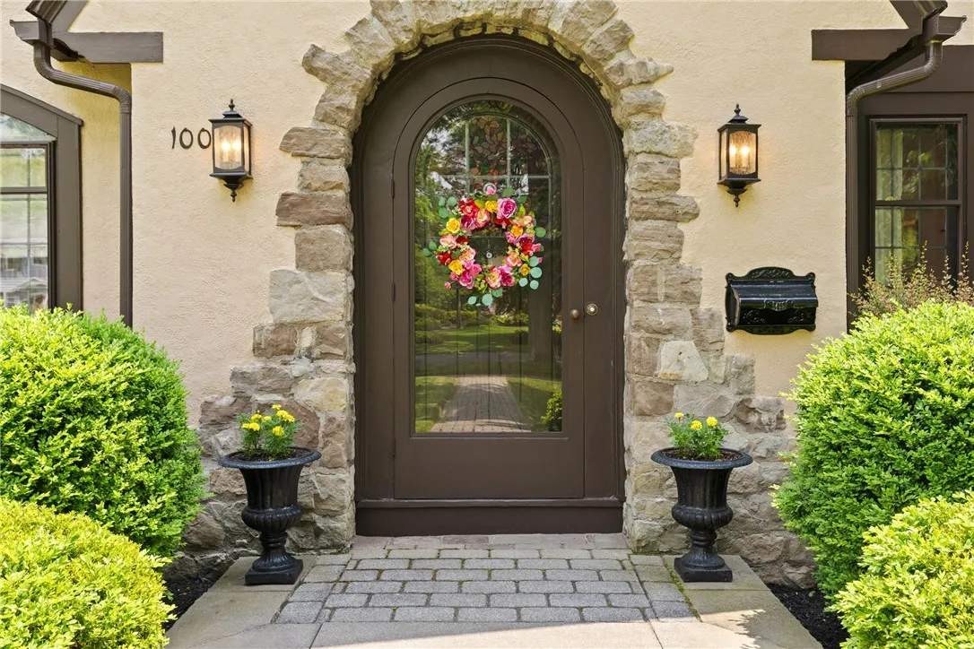 Every detail—from the symmetrical lighting to the lush greenery—reflects pride of ownership and timeless curb appeal.