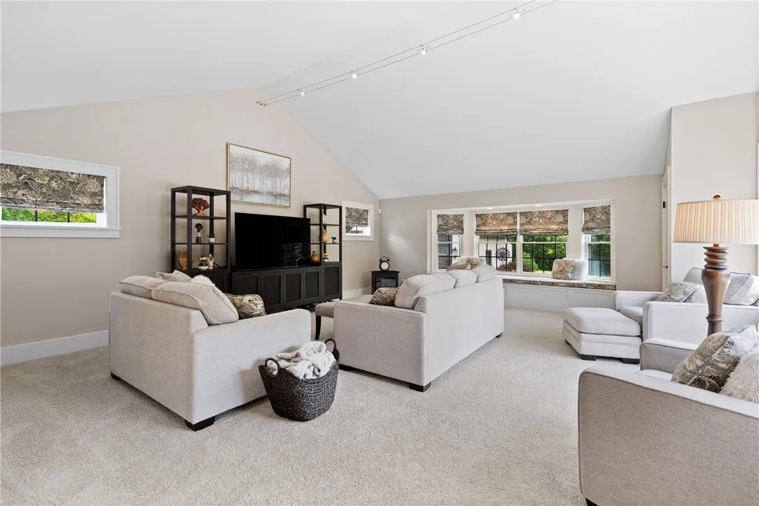 Enter into a large family room with vaulted ceilings, storage closets for games, music or outdoor gear, and views to the amazing back yard.