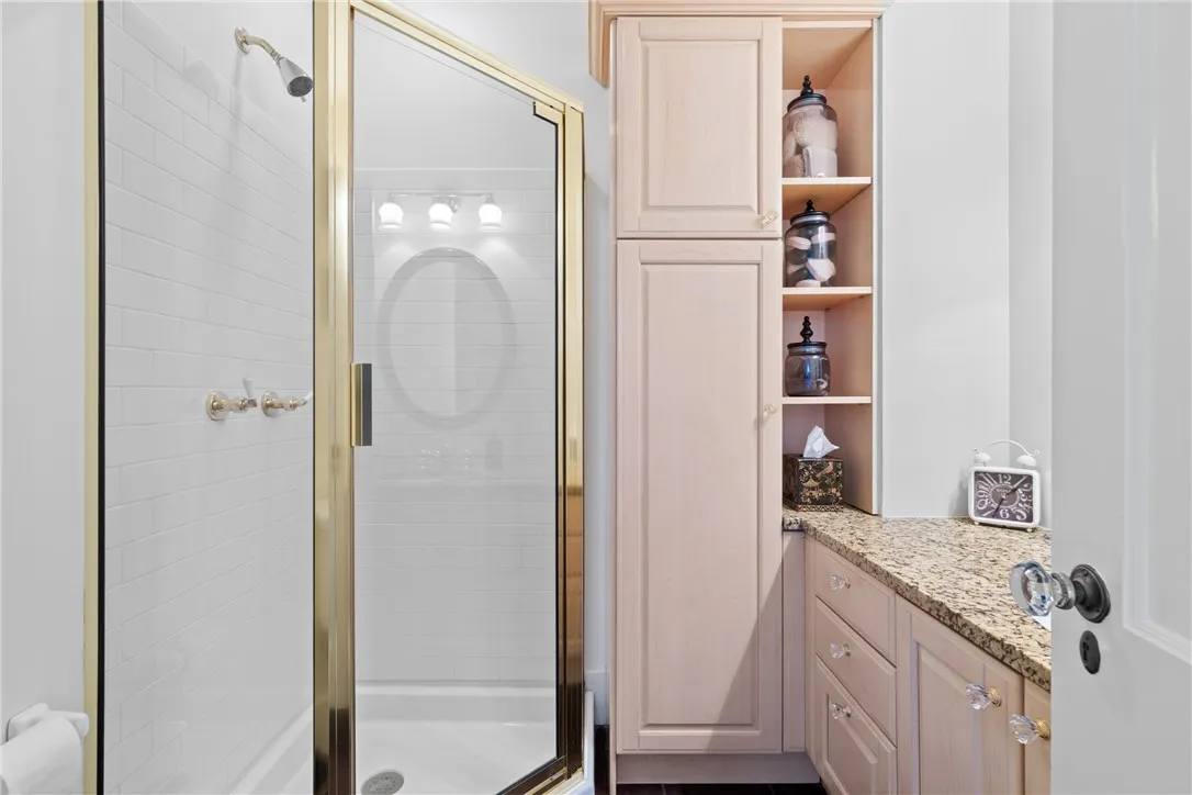 This first-floor full bath, complete with a shower, offers convenient access for quick clean-up after enjoying the pool.