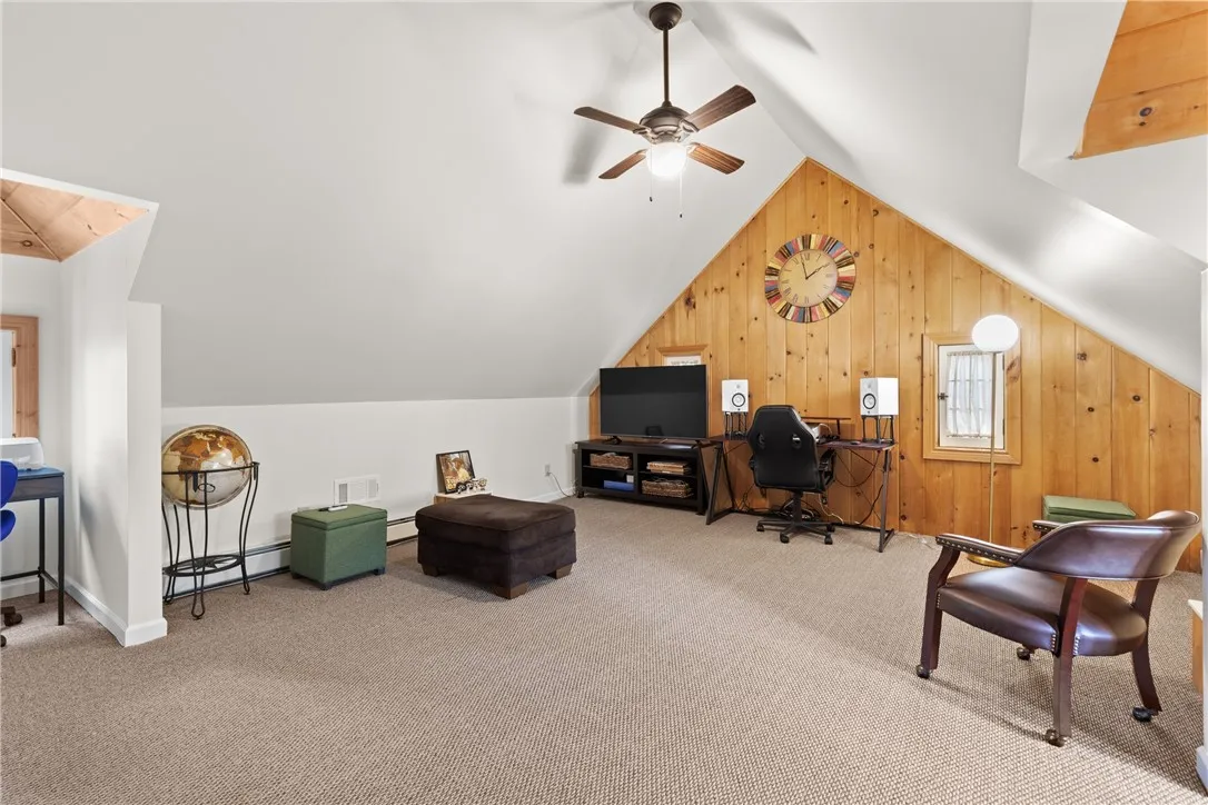 Vaulted ceilings, carpeting, ceiling fans, and inviting nooks enhance the charm and versatility of this flexible living space.