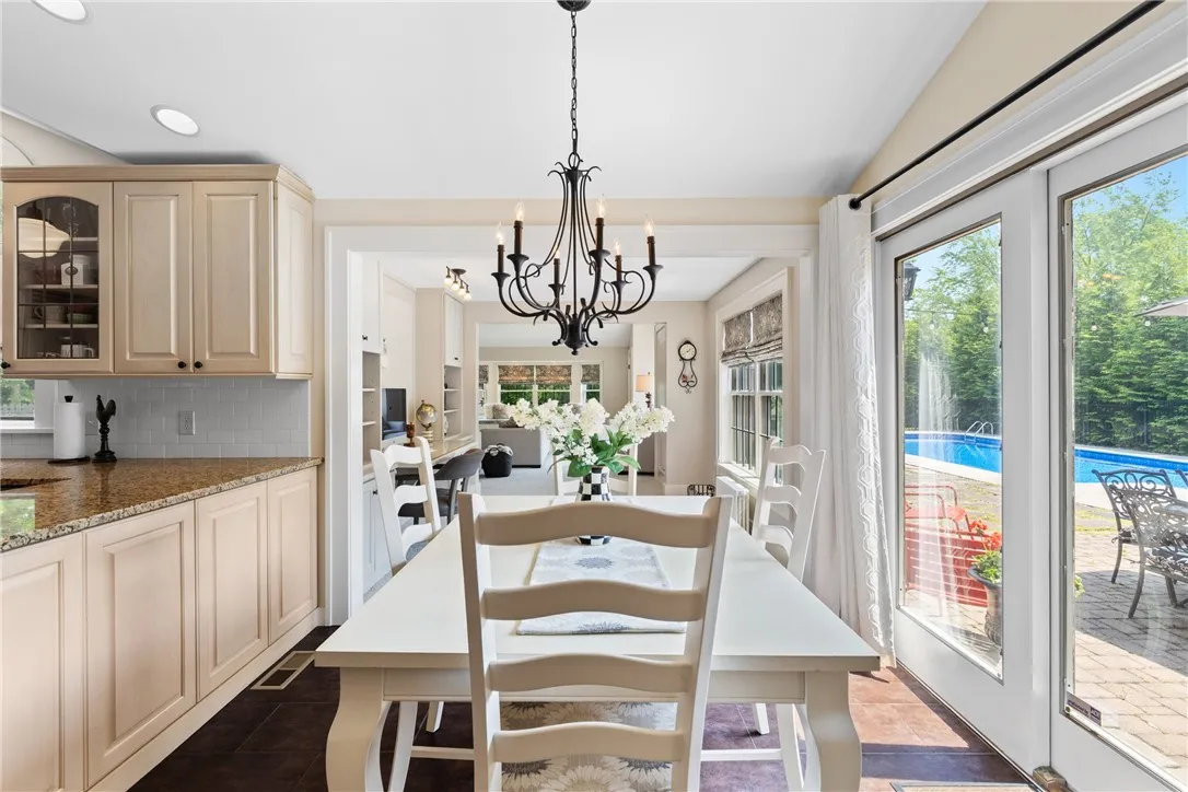 The bright eat in kitchen area has views of the pool and patio space.