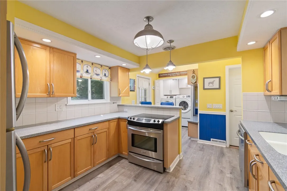 The BREAKFAST bar above the stove- laundry area - door to attached garage and there’s a patio style entryway to the right!