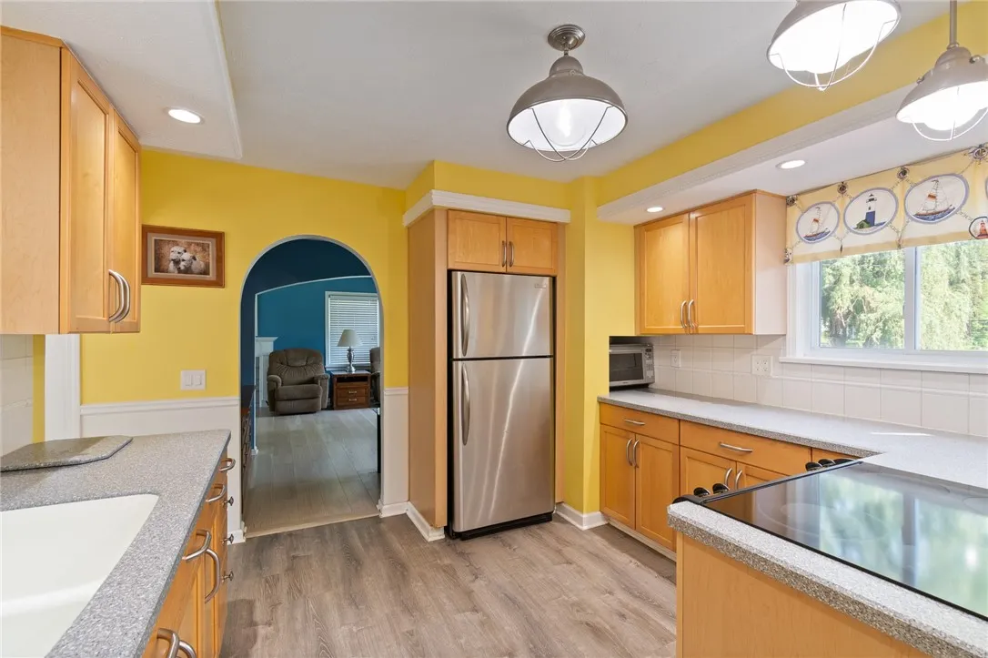 The kitchen- SOLID SURFACE counters- updated flooring and cabinets too! Check out the NEW lighting fixtures!