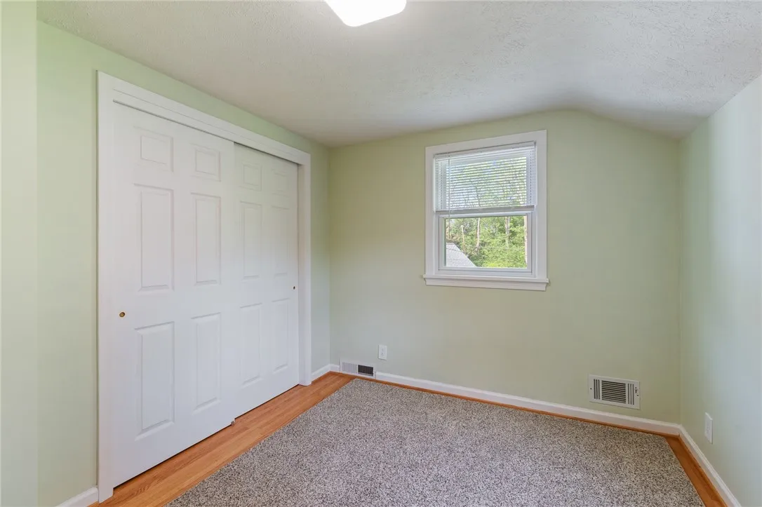 One of the three bedrooms- great space with real EASY TO CARE FOR hardwoods!