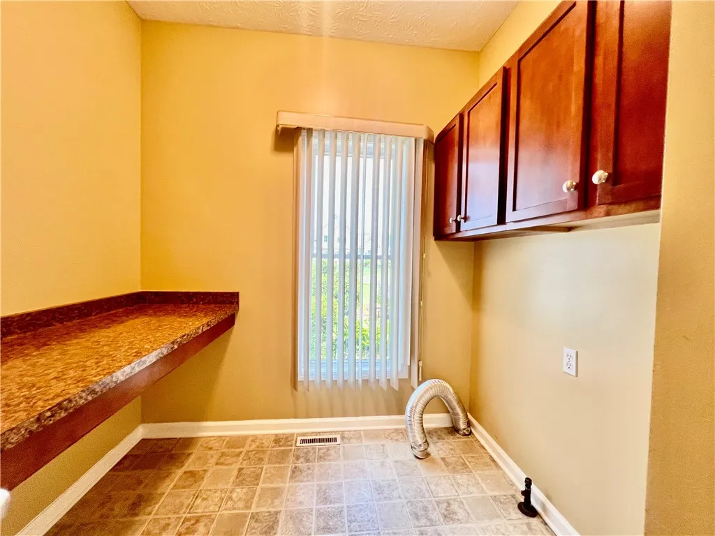 1st Floor Laundry Room with Cabinets and Pantry