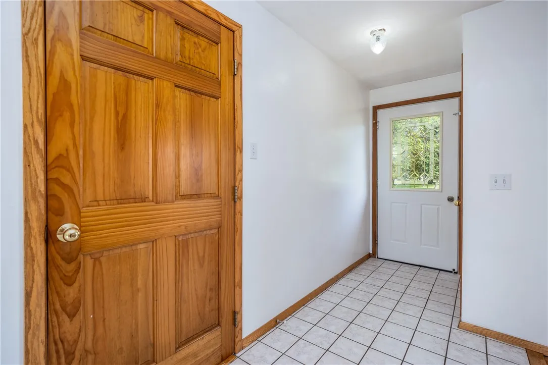 Tile foyer with guest coat closet