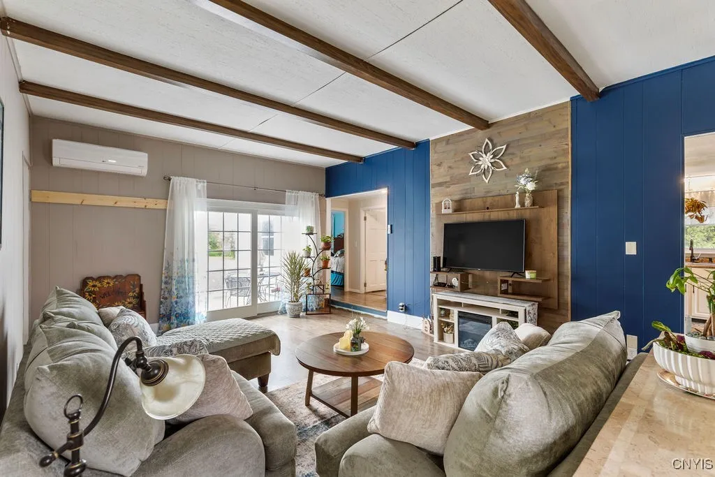 A wood accent wall and wooden beams add rich character