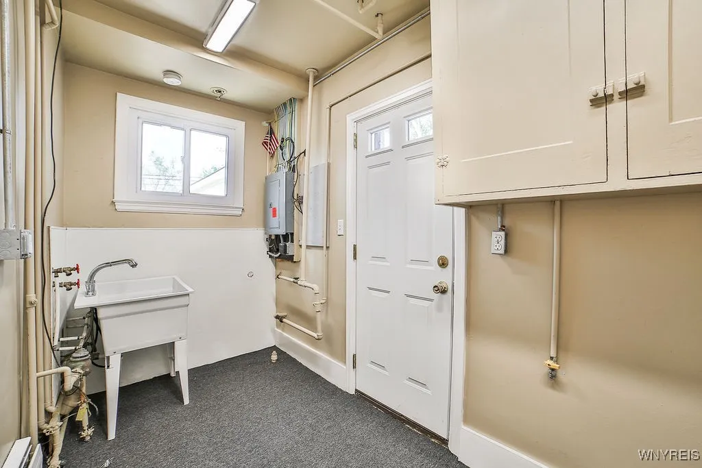 First floor, laundry, with updated electric panel and extra storage.