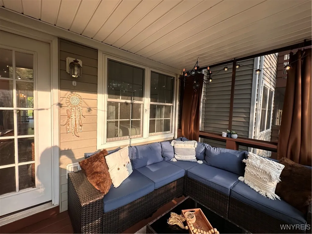 Balcony deck is covered and enclosed with custom screens for your enjoyment