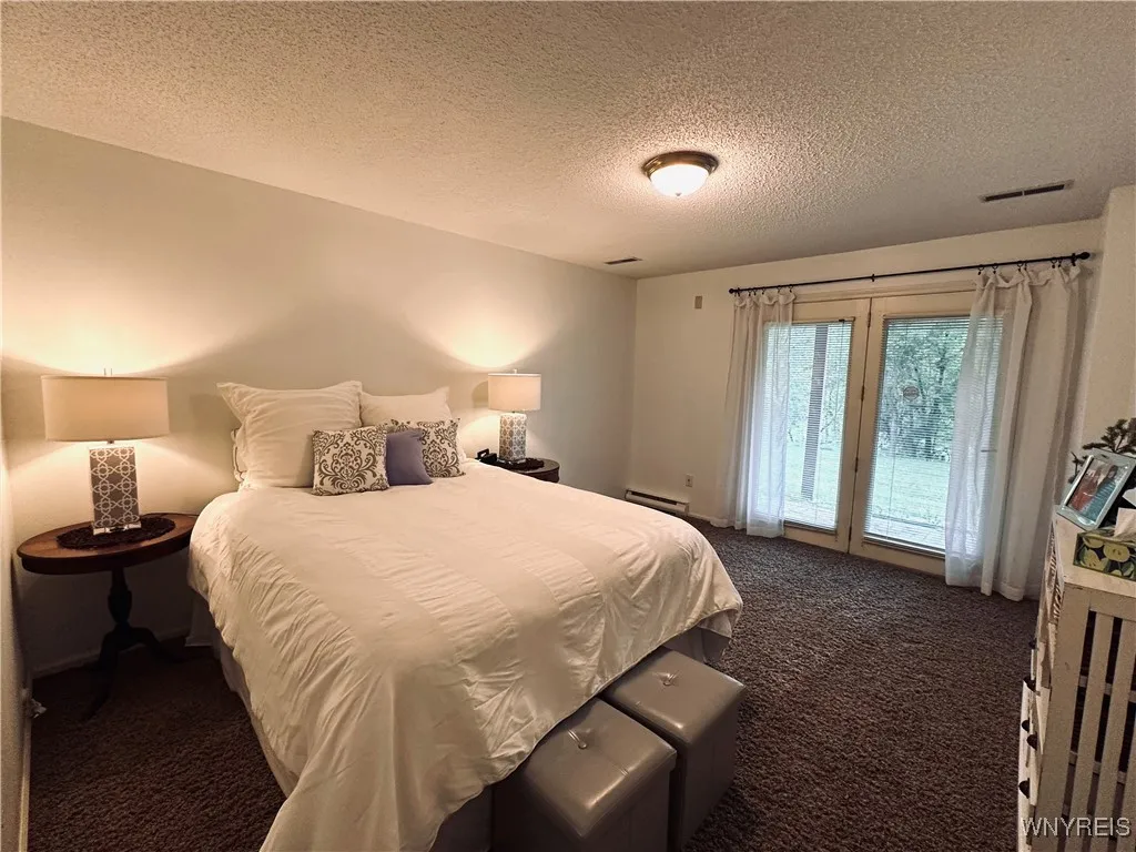 Lower level bedroom has slider to patio