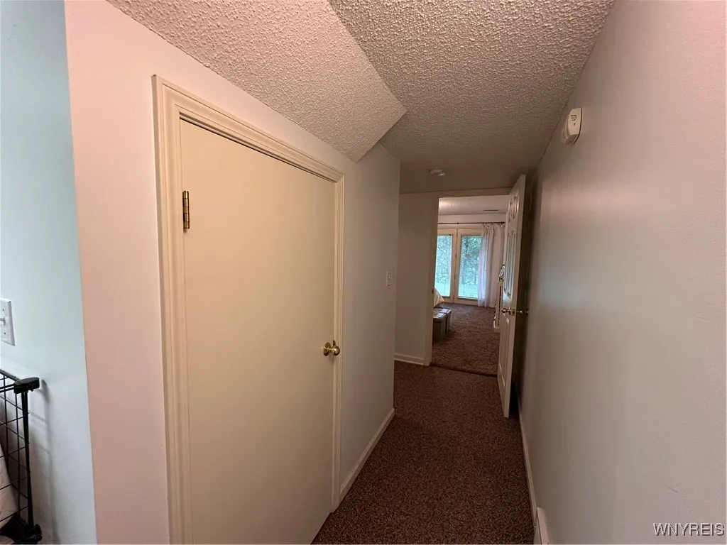 Hallway between bedroom #3 and laundry room with another closet
