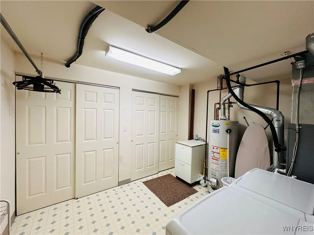 Huge laundry room has plenty of storage space and additional closets
