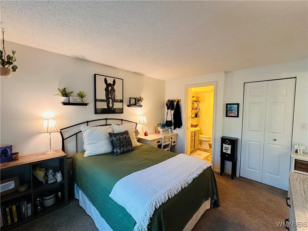 Primary bedroom with private bath and walk-in closet