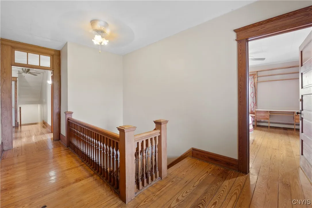 Upstairs Hallway with original woodwork and hardwood flooring throughout
