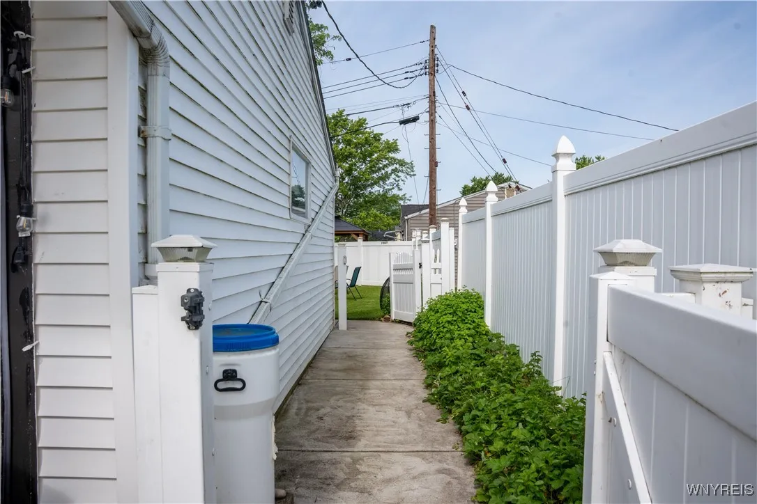 New concrete walkway from driveway to the backyard.