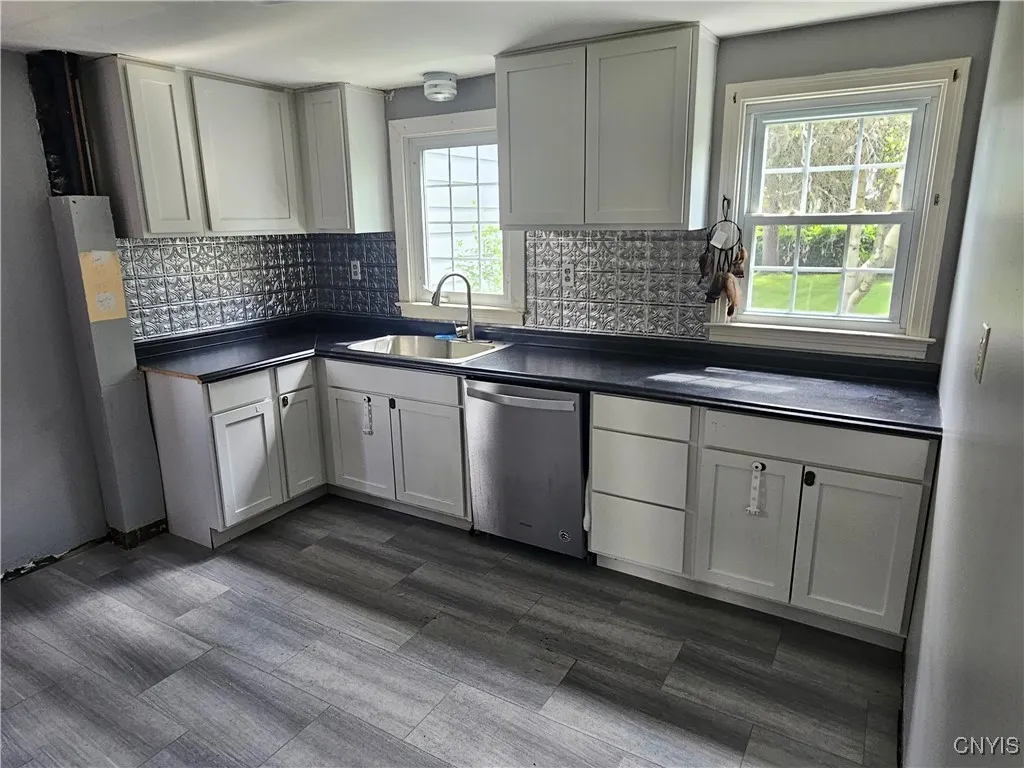 This renovated kitchen offers lots of natural lighting & a space for table & chairs.