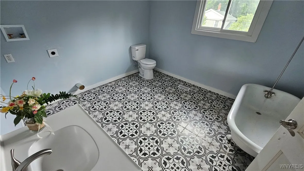 full bath with laundry hookuos and claw tub