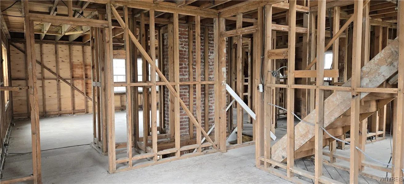 Upper Looking from Bedroom into the Living Room Space and staircase to the walk-up attic