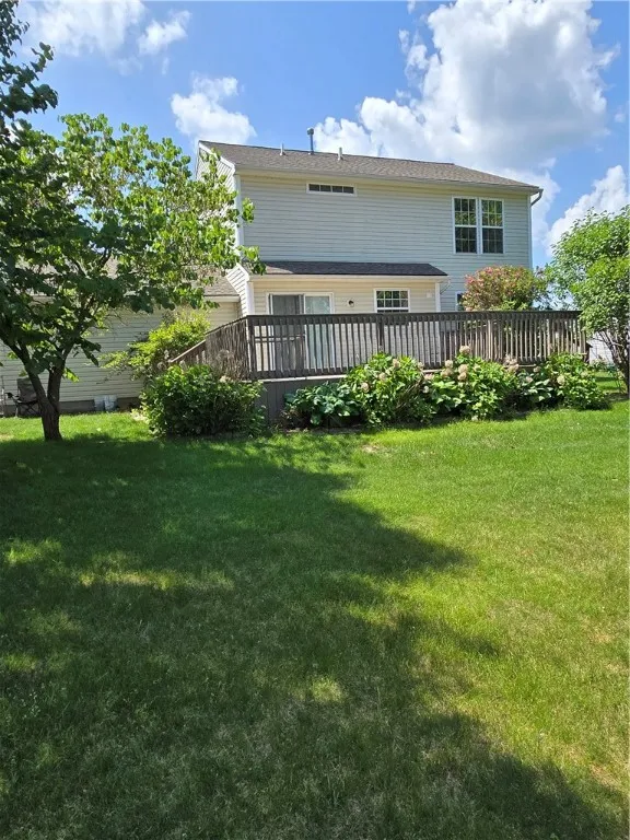 Rearview of house with deck and  well cared garden