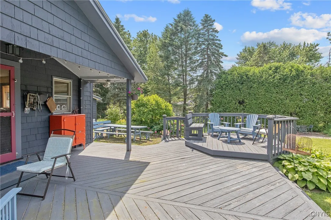 Heading outside we find the back deck, which is partially covered so can be enjoyed on those rainy days as well. And the adorable hexangular area is so inviting!