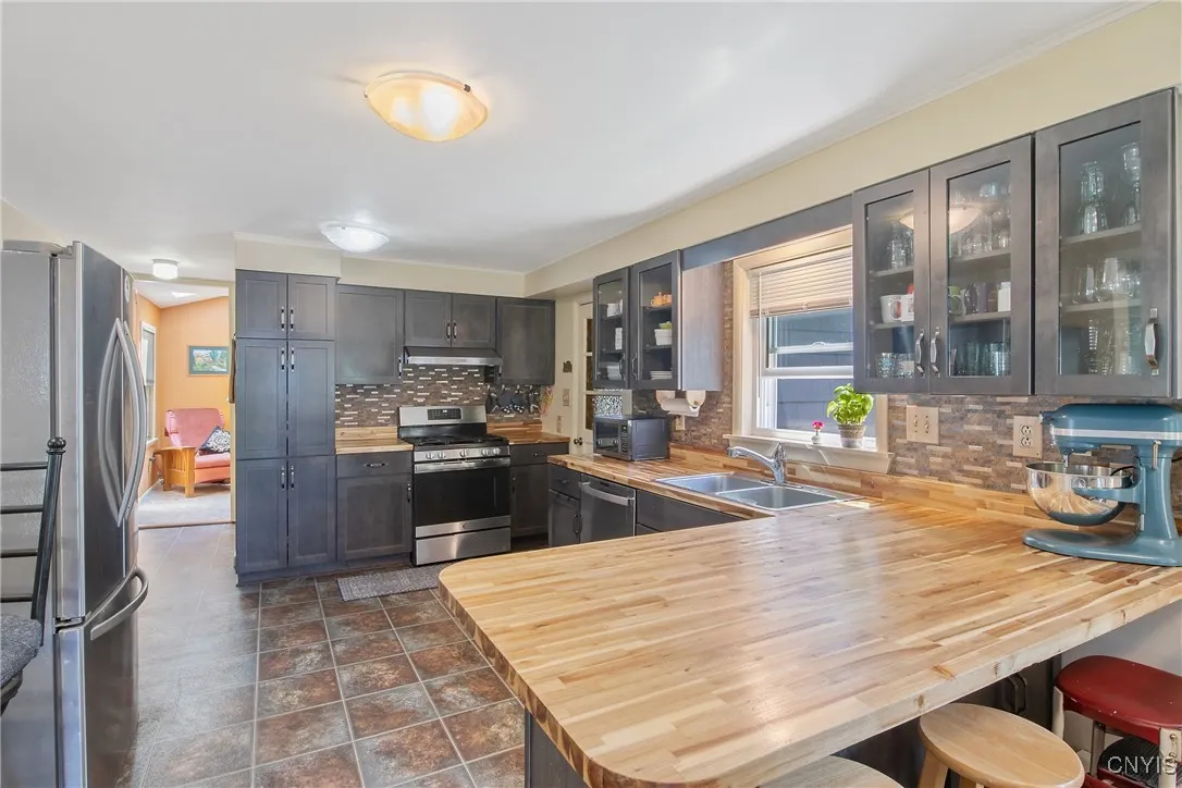 This gorgeous butcher block countertop serves as the perfect cooking/baking area and/or the perfect spot for a casual meal or snack!
