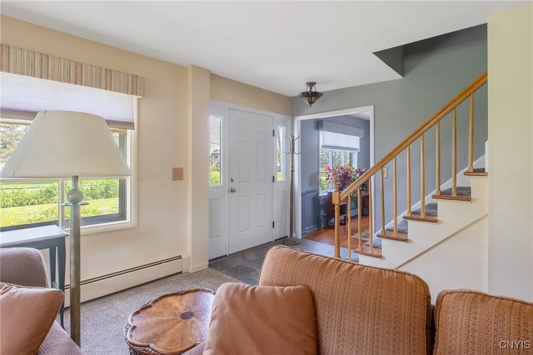 From this vantage point, you can see the stairs that greet you, leading to the second level, and a peak into the formal dining room.