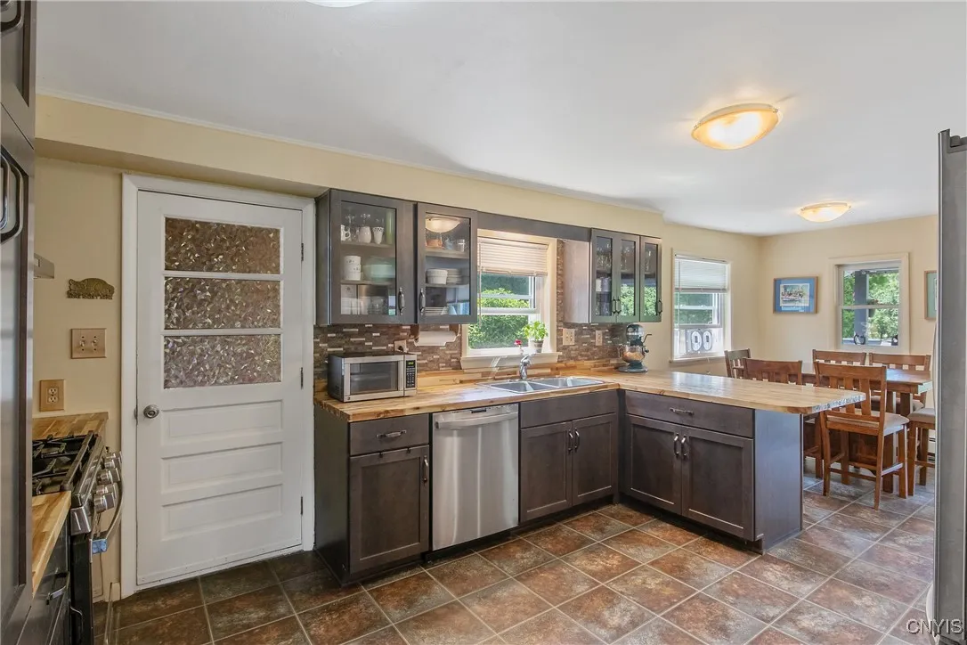 This door leads to the two car garage and provides a wonderful entrance from outside right into the kitchen. The large windows offer a beautiful view into the private yard!