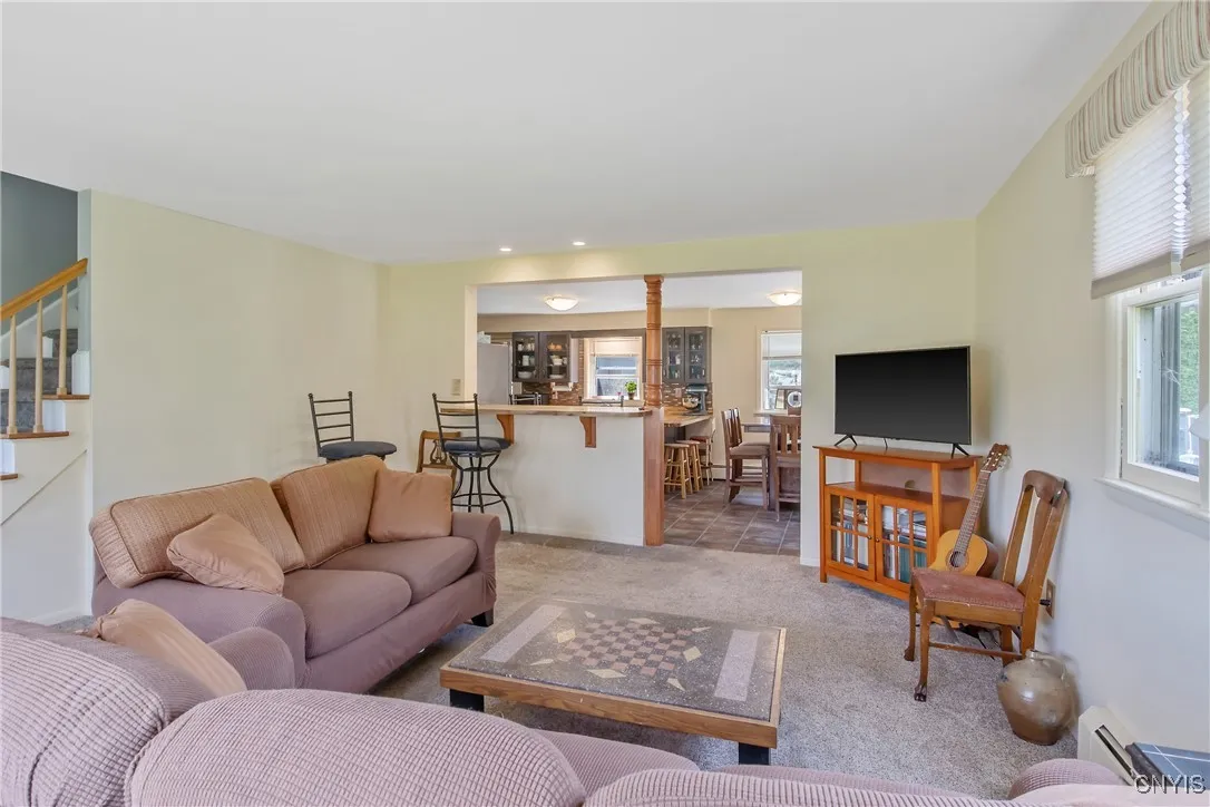 Looking toward the rear of the house, you will see the open kitchen complete with breakfast bar, eat-in area, and countertop that can also be used for seating.