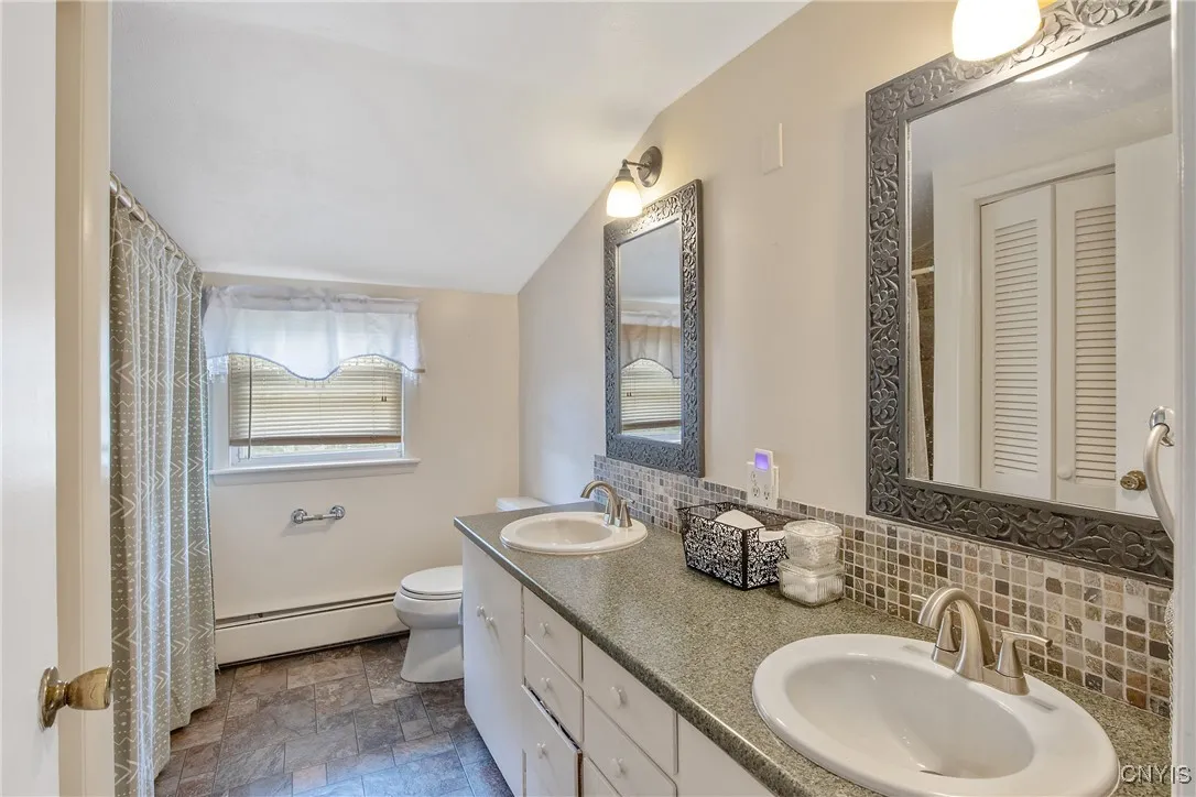 Immediately adjacent to the primary bedroom is the updated bathroom with dual sinks and lots of counterspace.
