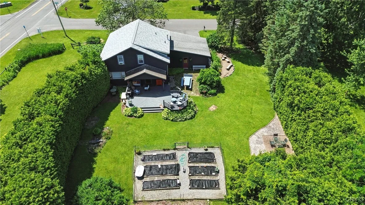This lot has it all - corner lot, established gardens, hedges, trees, gathering spaces, and a vegetable garden bed!