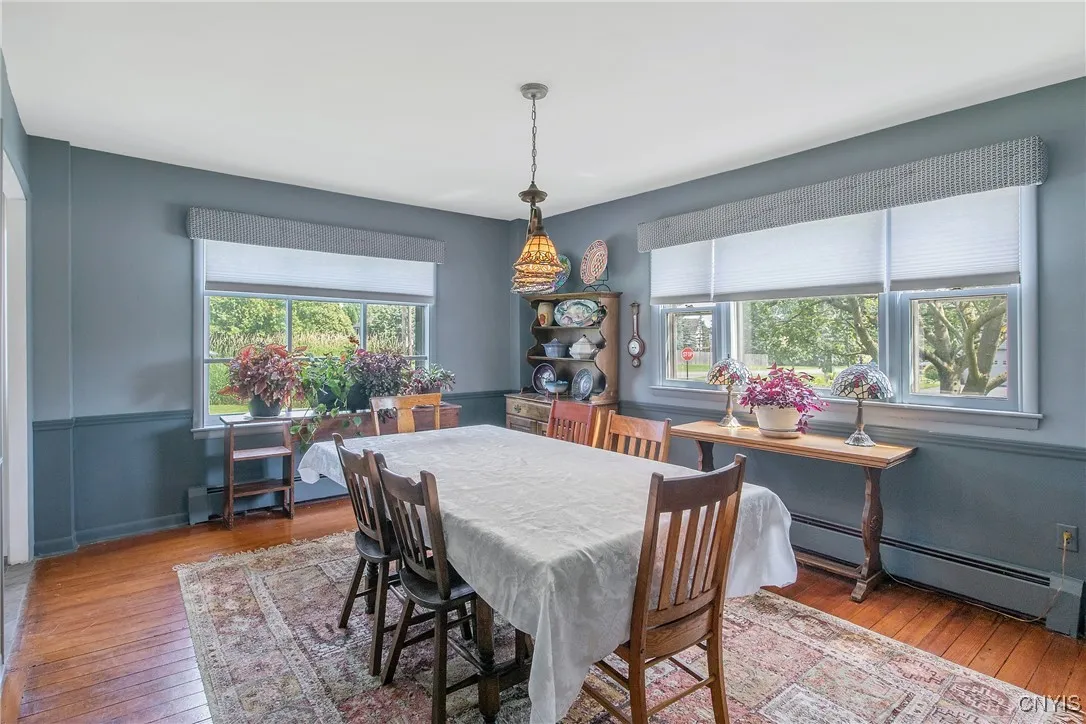 Stepping from the kitchen into the formal dining room, you are greeted by more picture windows letting in all that wonderful natural light.