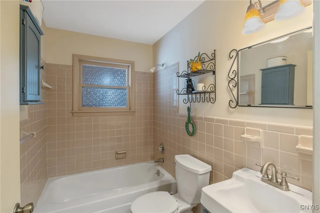 This sparkling, well-placed full bath is just off the kitchen.
