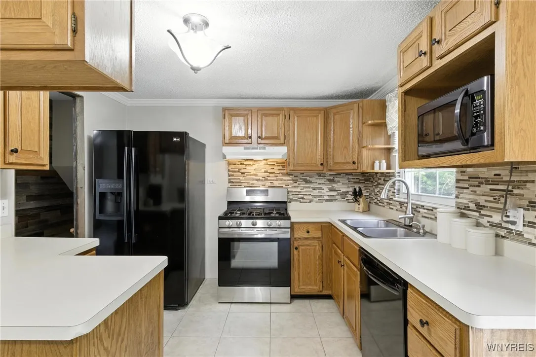 Kitchen includes the appliances.  Tile backsplash and flooring.